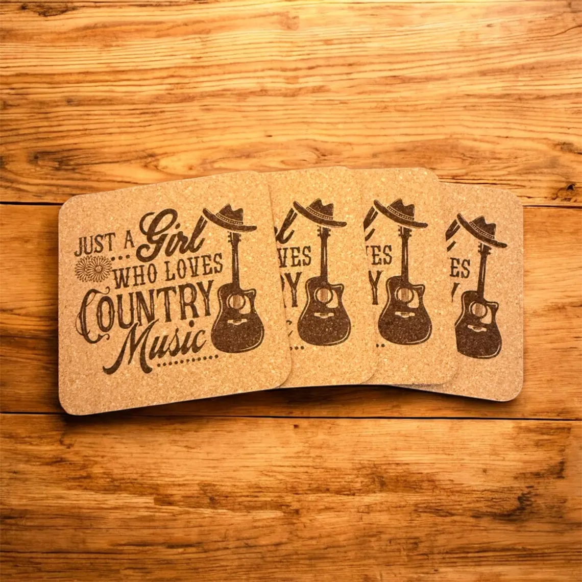 Cork coasters laser engraved with a guitar and cowboy hat reading 'Just a Girl Who Loves Country Music'