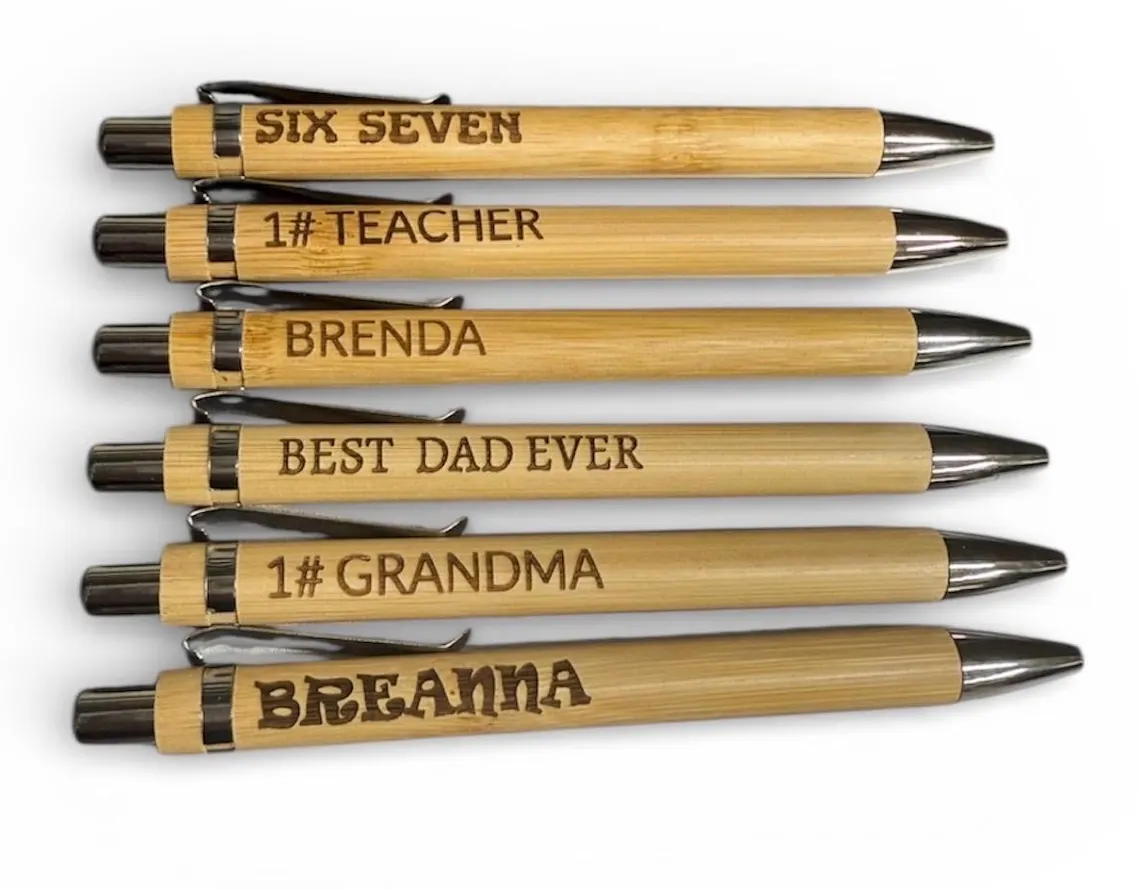 Bamboo pens laser engraved with custom names and phrases like 'Six Seven', '1# Teacher', and 'Best Dad Ever'
