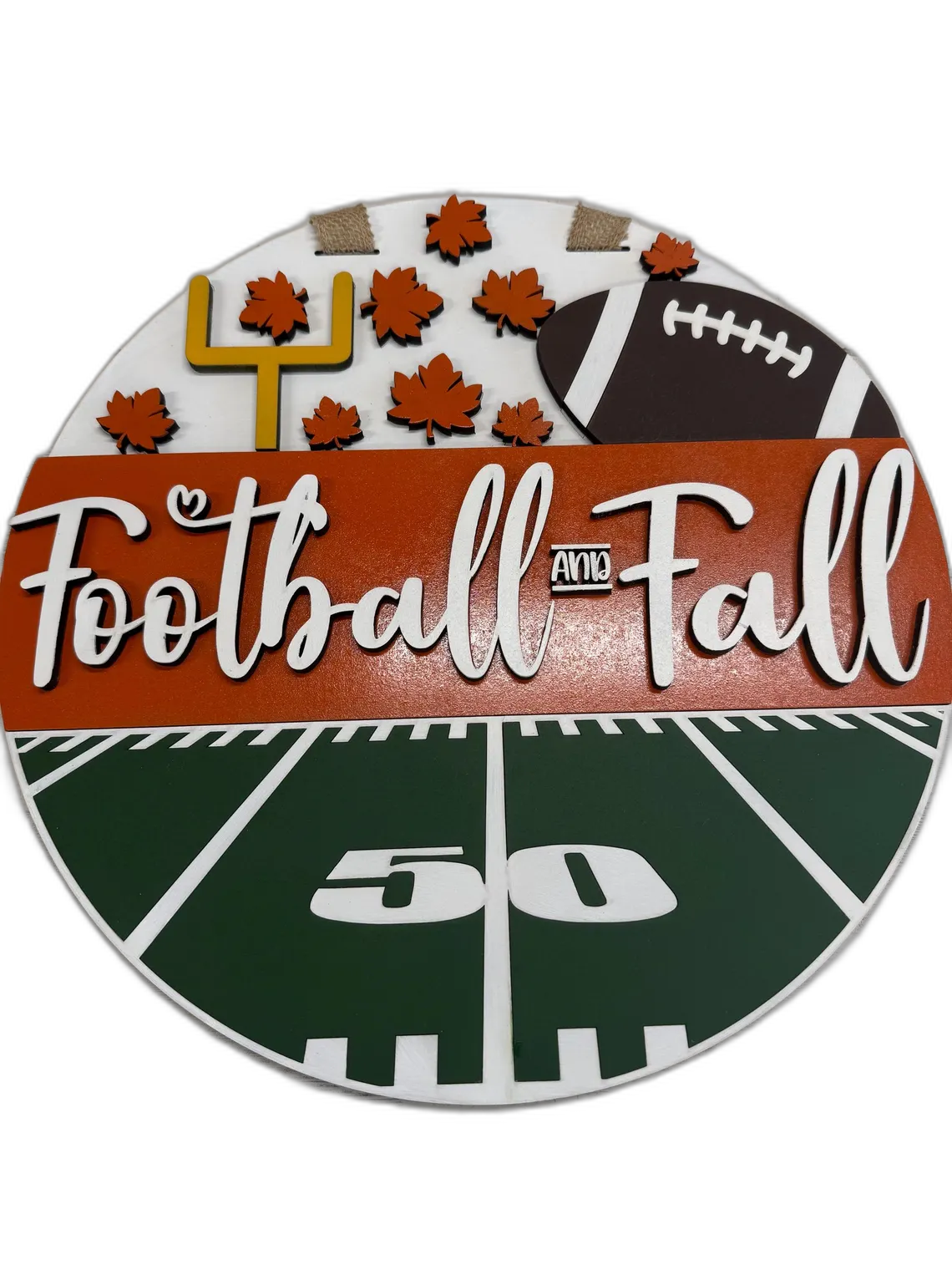 Round wood sign with a football field, goal post, autumn leaves, and 'Football and Fall' lettering