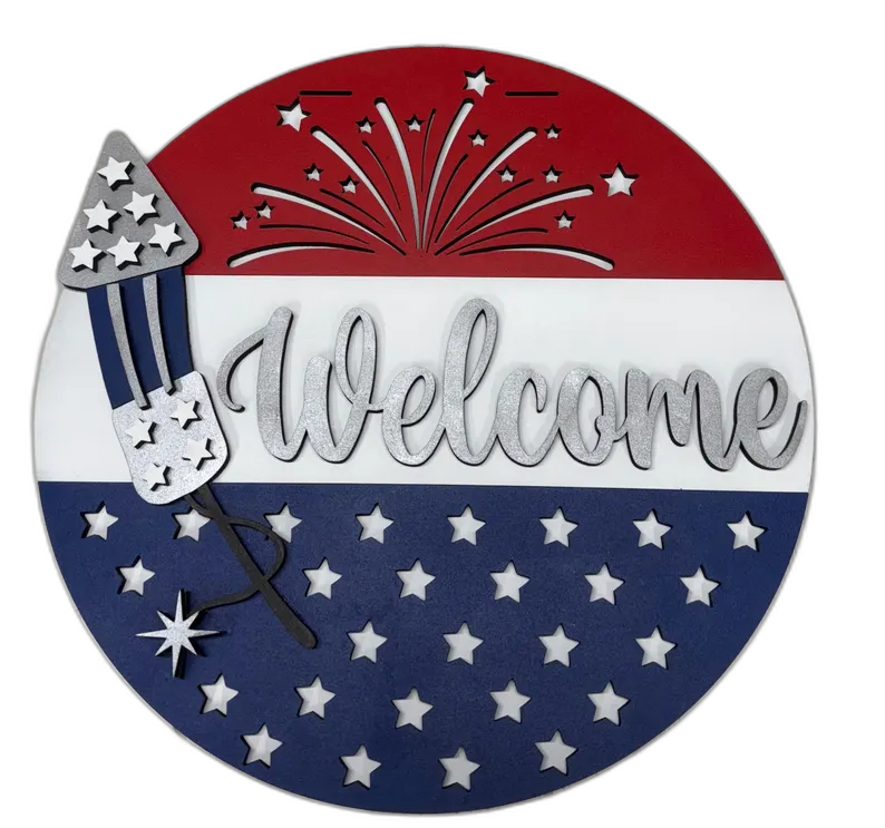 Round red white and blue wood sign with a firework rocket and 'Welcome' script lettering